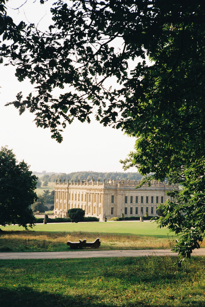 Large classical building in a park with trees and open space, shot with Fujifilm 200 - 35mm film