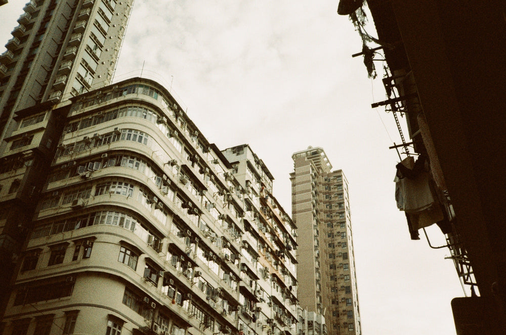 Tall buildings in an urban setting with a cloudy sky, show with Lomography Metropolis - 35mm film