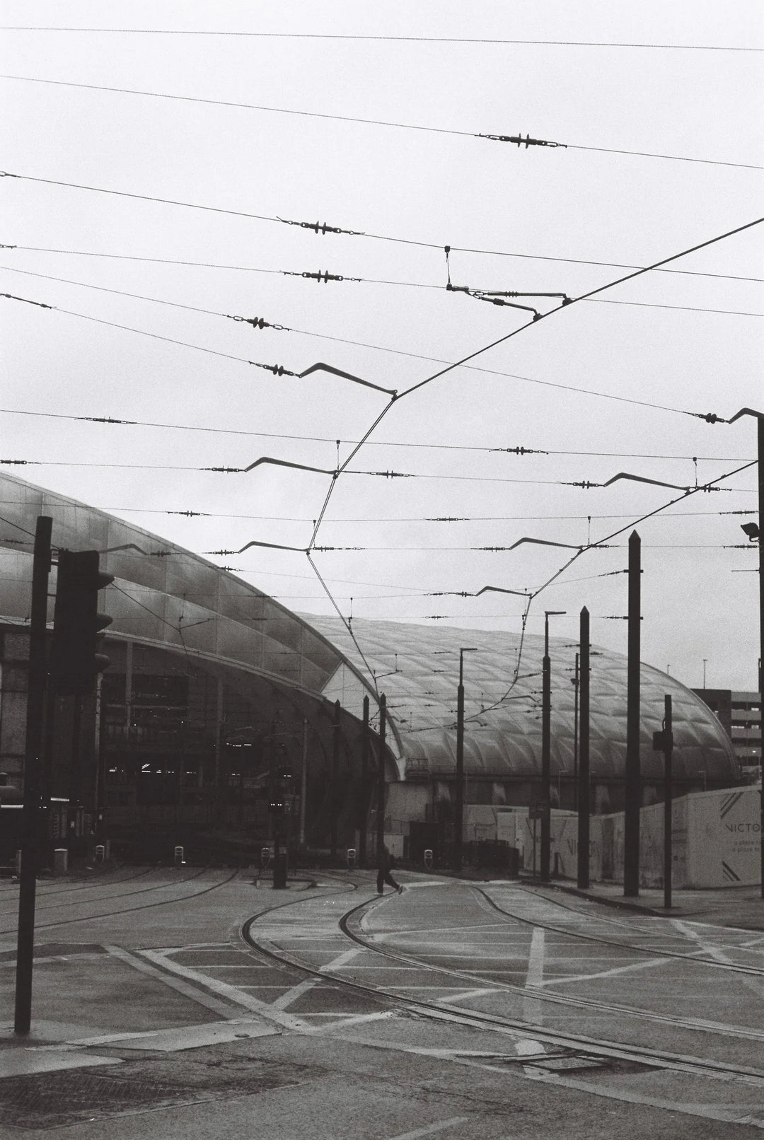 Tramline in Manchester captured on Ilford HP5 Plus 400 35mm film, showing urban streetscape with fine grain and expressive tonal range.
