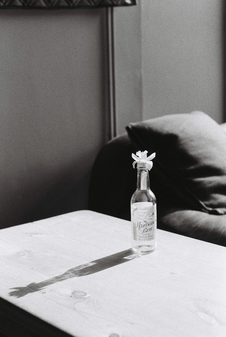 Vase on a desk photographed using Kentmere Pan 400 35mm black and white film, with sharp detail and tonal depth