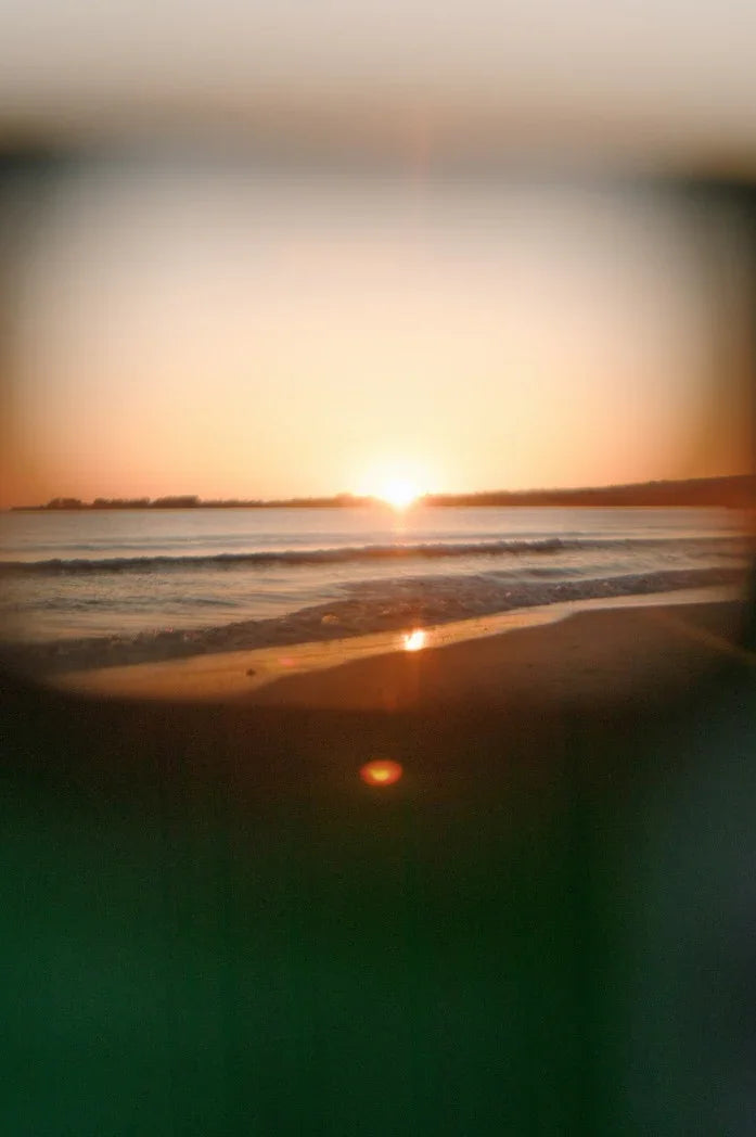 Sunset captured on Kodak FunSaver disposable camera with built-in flash, showing vibrant analog colours