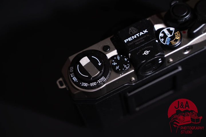 Pentax 17 35mm film camera with half-frame format, seven shooting modes, and zone-focus system, top left