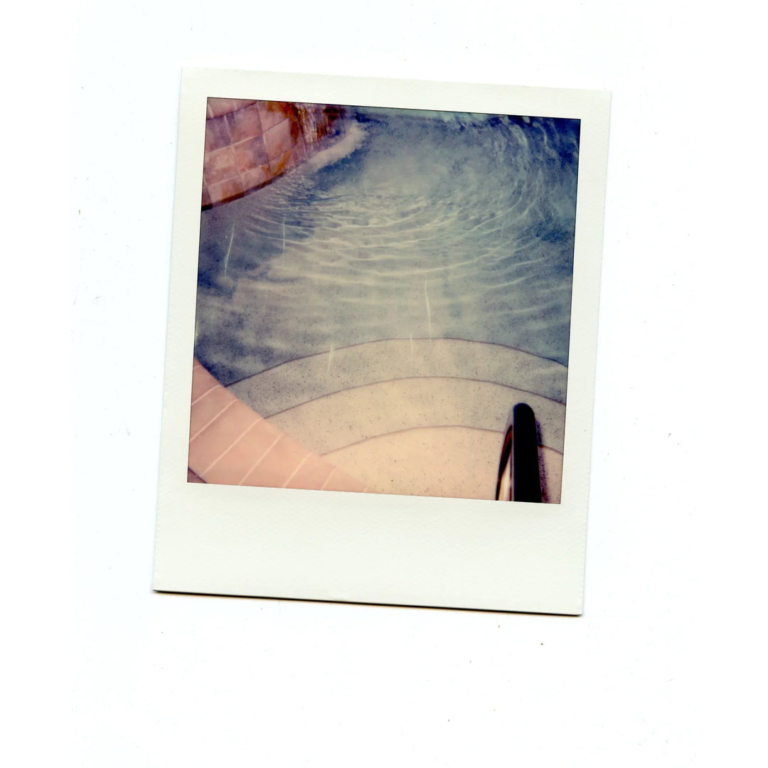 Water close-up captured on Polaroid 600 Colour Instant Film with classic instant photo tones