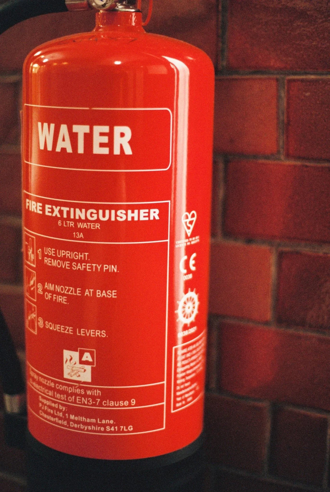 Fire extinguisher photographed using Cinestill 400D film, showcasing sharp details and natural tones