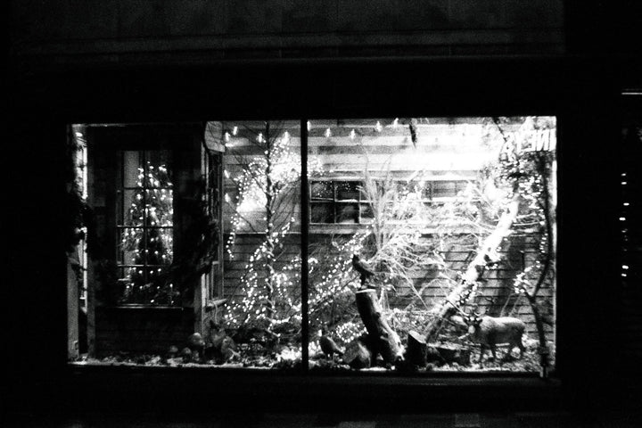 Night shot of a Christmas market captured on Ilford Delta 3200 35mm film, showing festive lights, fine grain, and deep contrast.