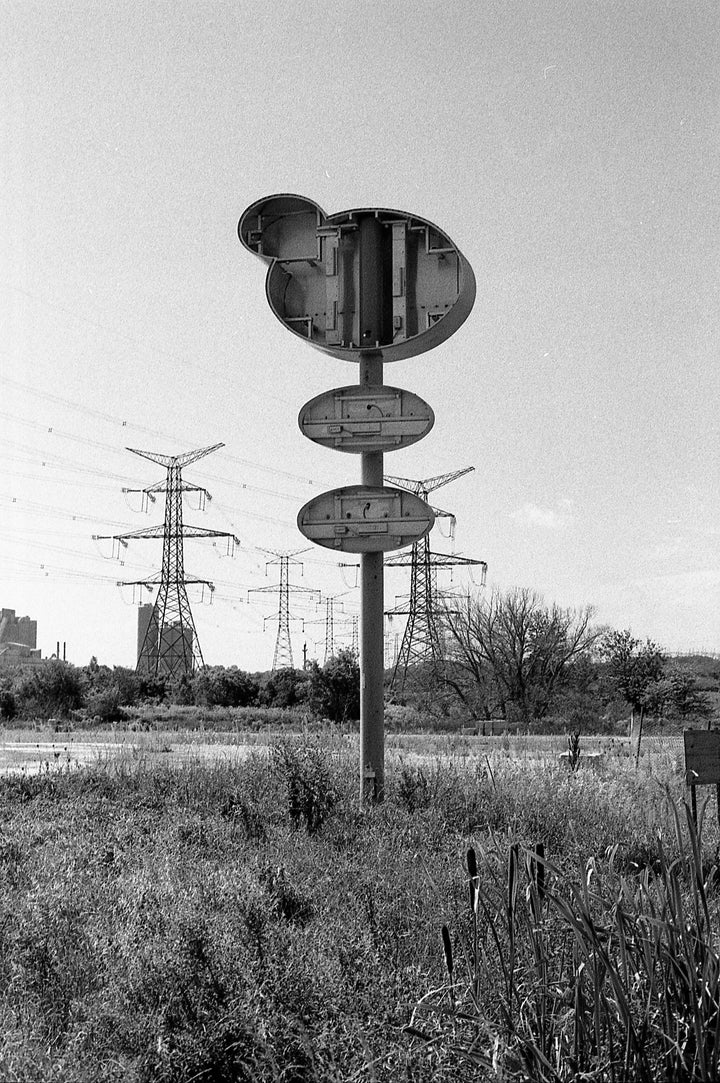 Road sign photographed on Ilford HP5 400 Plus film, highlighting sharp detail, strong contrast, and classic black and white film aesthetic.