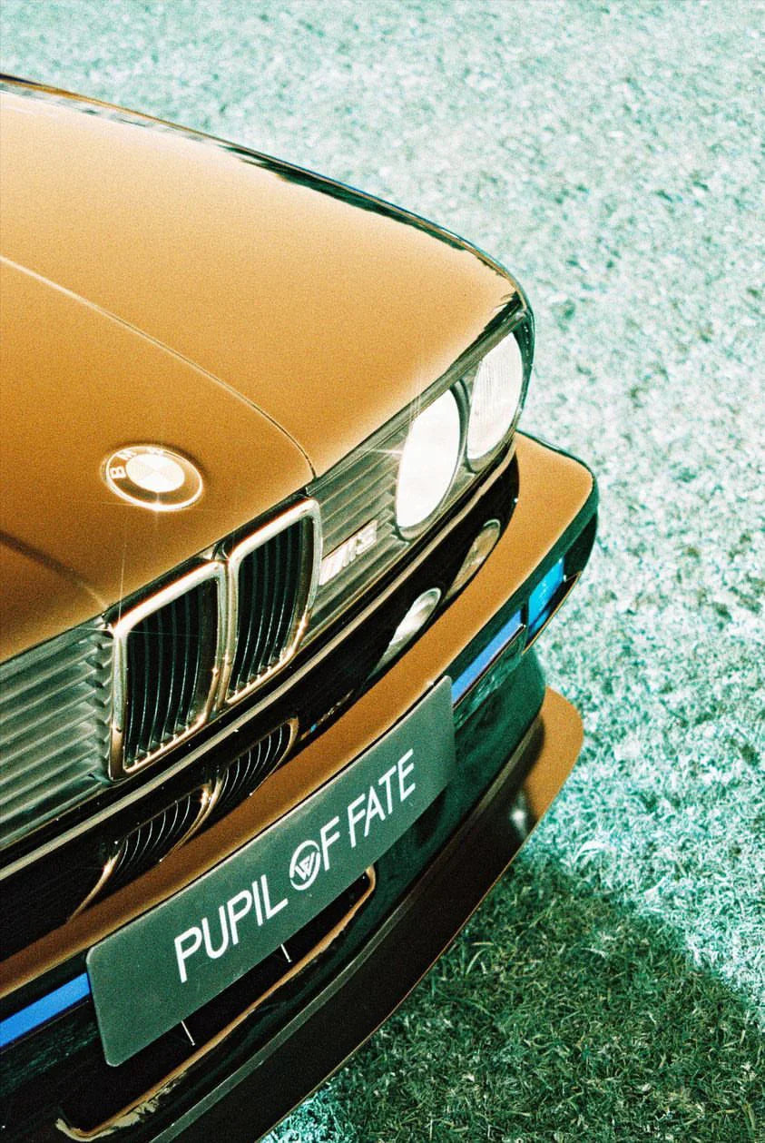 Close-up detail of a car hood captured with Lomography Lomochrome Turquoise film, showing creative blue-green color shifts.