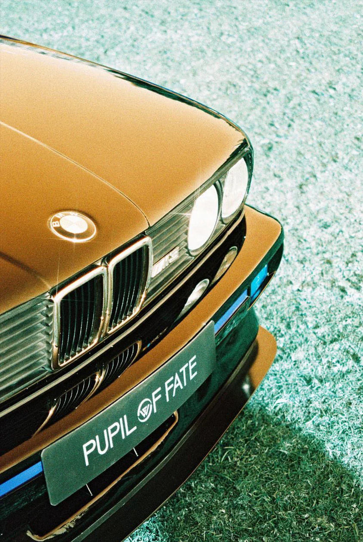 Close-up detail of a car hood captured with Lomography Lomochrome Turquoise film, showing creative blue-green color shifts.